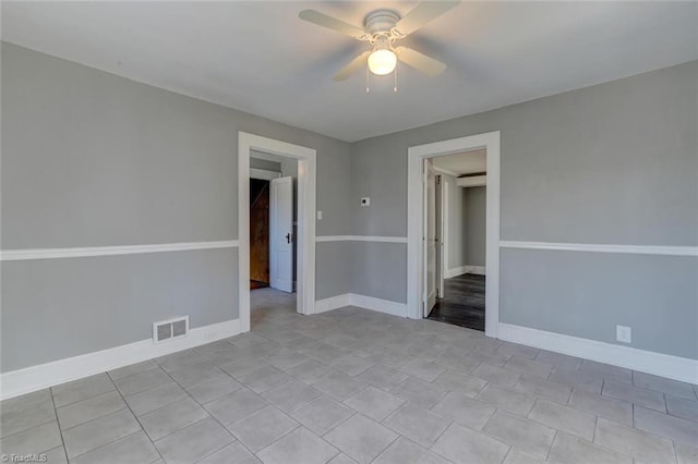 interior space with ceiling fan and light tile patterned floors