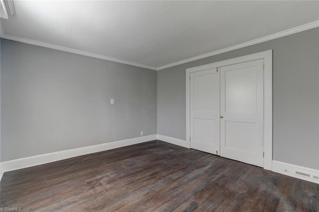 unfurnished bedroom featuring ornamental molding, a closet, and wood-type flooring