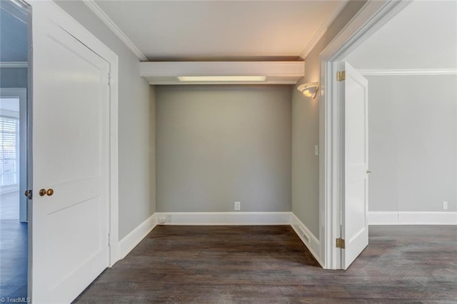 spare room featuring crown molding and dark hardwood / wood-style flooring