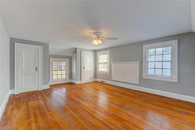 unfurnished living room featuring ceiling fan, light hardwood / wood-style flooring, and a healthy amount of sunlight