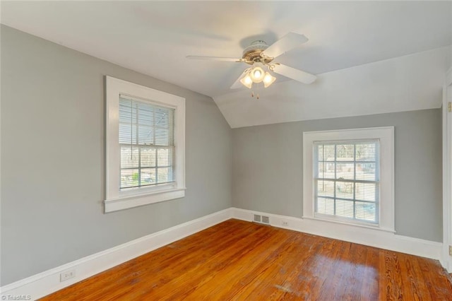 bonus room featuring a wealth of natural light, ceiling fan, vaulted ceiling, and hardwood / wood-style flooring