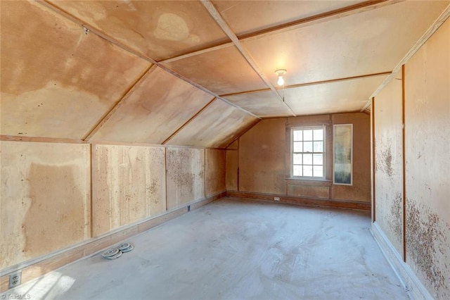 additional living space featuring lofted ceiling