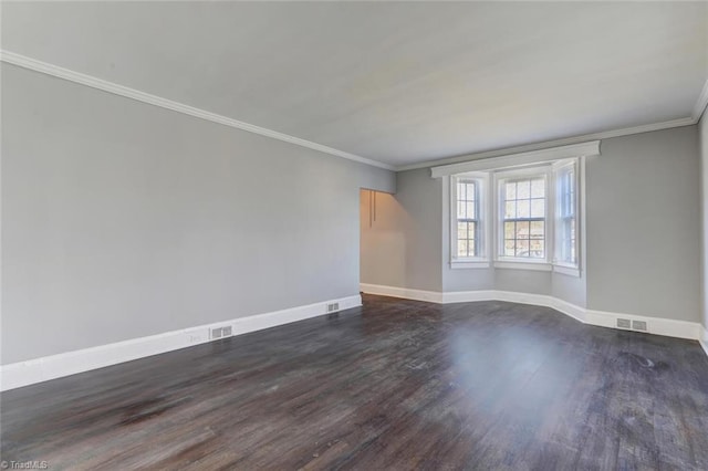 empty room with dark wood-type flooring and ornamental molding