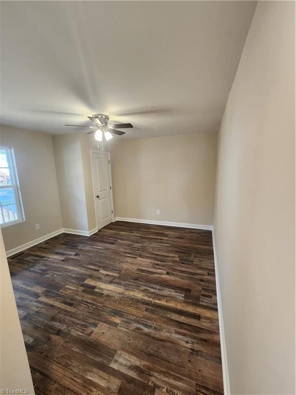 empty room featuring dark hardwood / wood-style floors and ceiling fan