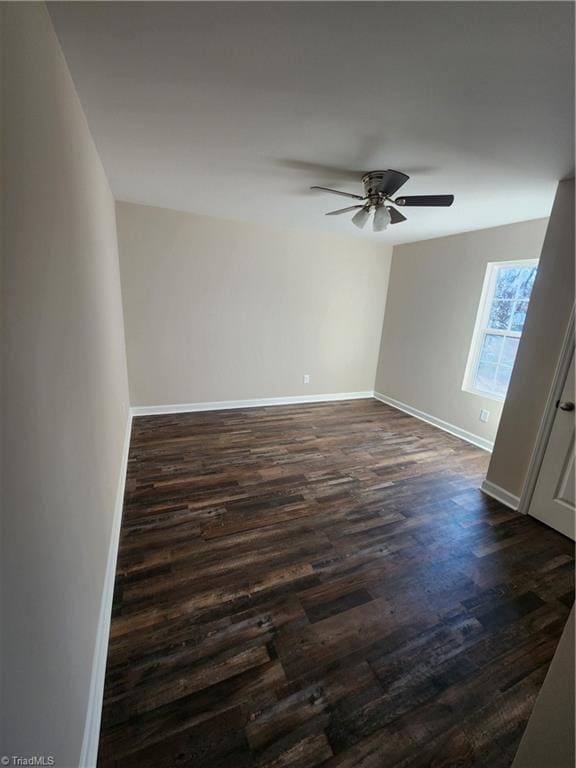 unfurnished room featuring ceiling fan and dark wood-type flooring