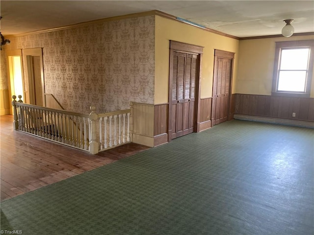 spare room with crown molding and a baseboard heating unit