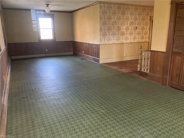 spare room featuring crown molding and a baseboard radiator