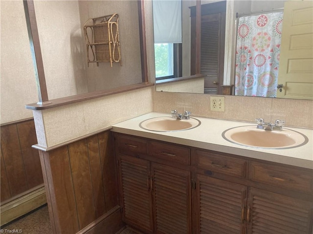 bathroom featuring vanity and backsplash