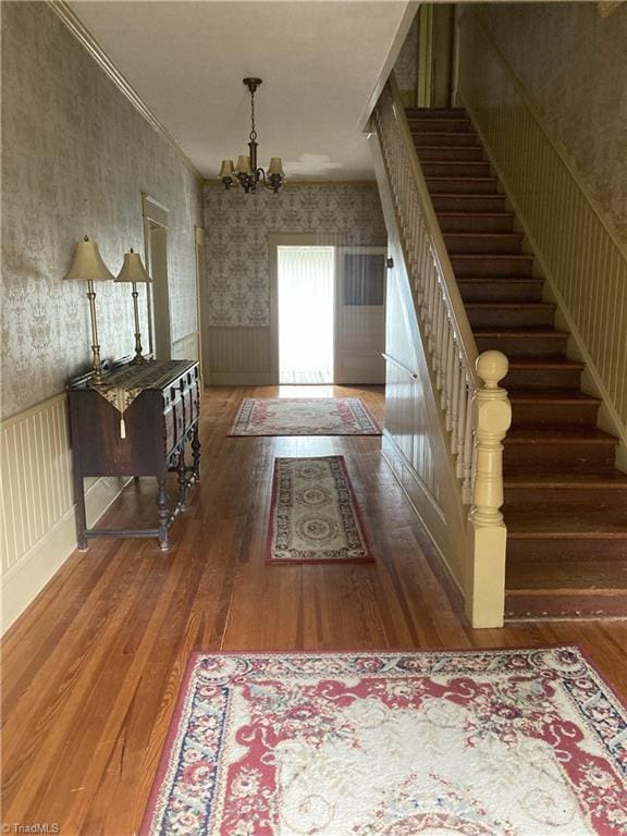 interior space with a notable chandelier and hardwood / wood-style flooring