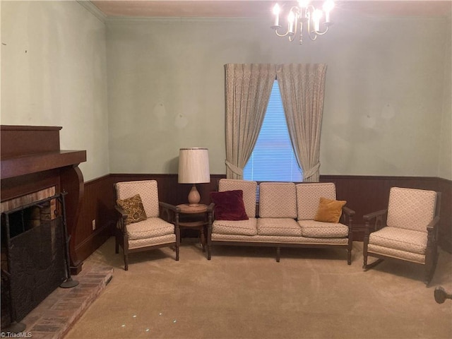 living room featuring wooden walls, a notable chandelier, ornamental molding, a brick fireplace, and light colored carpet