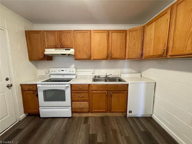 kitchen featuring dark wood-style flooring, under cabinet range hood, brown cabinets, a sink, and white electric stove