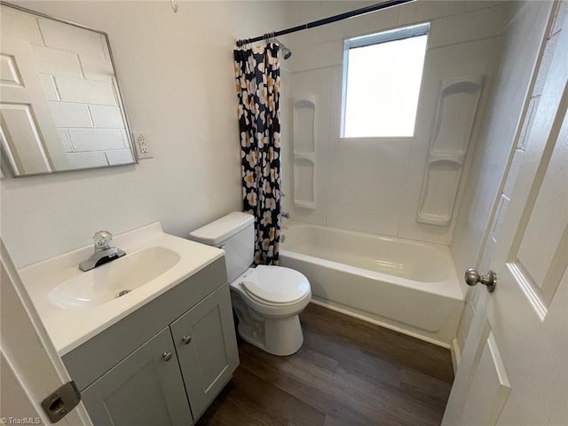 bathroom with vanity, shower / tub combo with curtain, wood finished floors, and toilet