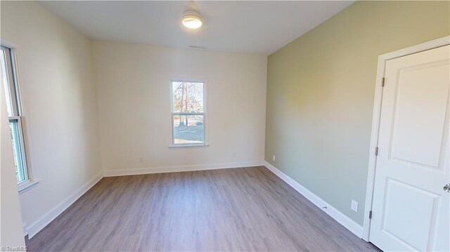 spare room featuring hardwood / wood-style flooring