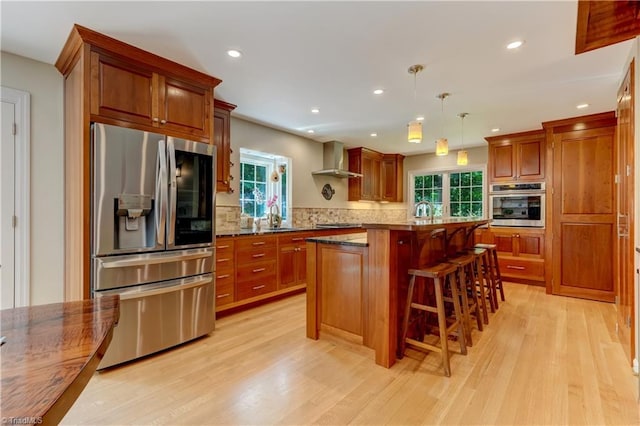 7 Pineburr Ct, Greensboro, NC 27455 - kitchen with stainless steel appliances, a sink, wall chimney range hood, healthy amount of natural light, and recessed lighting