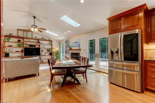 7 Pineburr Ct, Greensboro, NC 27455 - dining area featuring lofted ceiling, french doors, ceiling fan, a skylight, and light wood-style floors