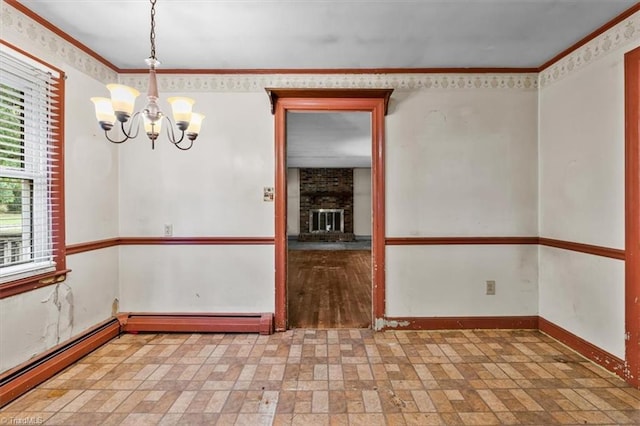 unfurnished room featuring a chandelier, baseboards, ornamental molding, a fireplace, and a baseboard heating unit