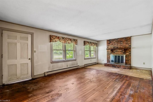 unfurnished living room with a baseboard heating unit, hardwood / wood-style floors, and baseboards