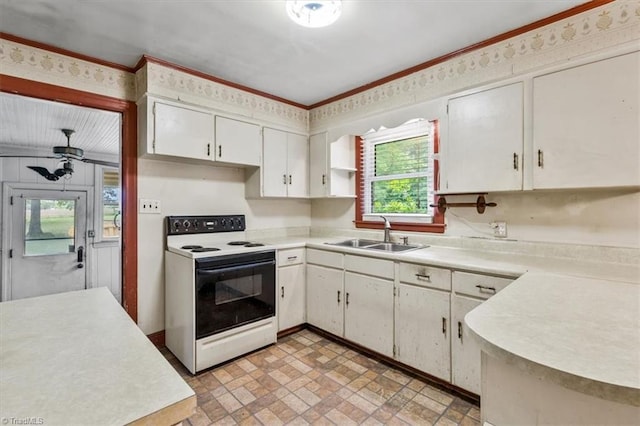 kitchen featuring electric stove, a sink, light countertops, white cabinetry, and crown molding