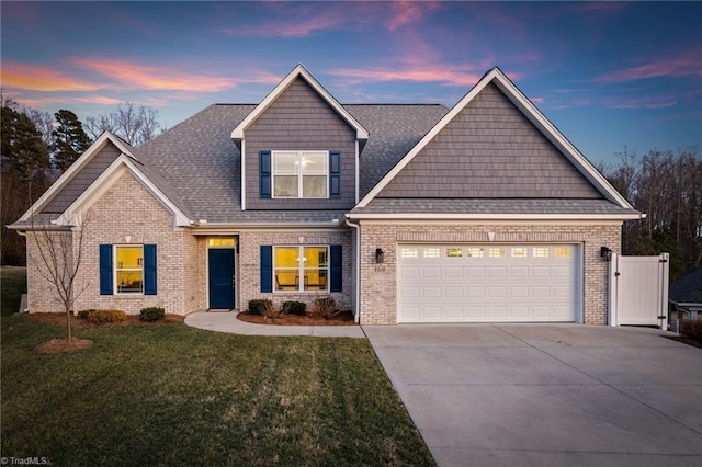 view of front facade with a garage and a lawn