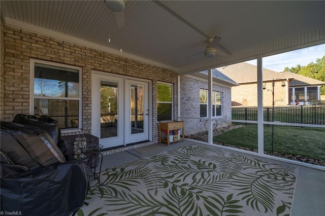 sunroom / solarium with french doors and ceiling fan