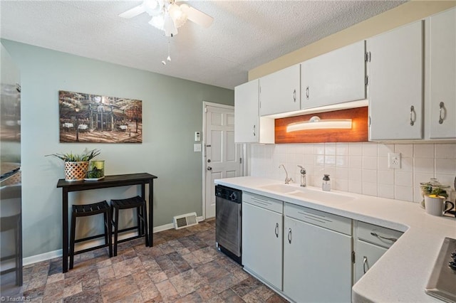 kitchen with dishwasher, tasteful backsplash, visible vents, and a sink