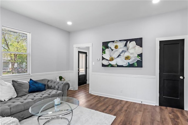 living area featuring recessed lighting, wainscoting, and dark wood-type flooring