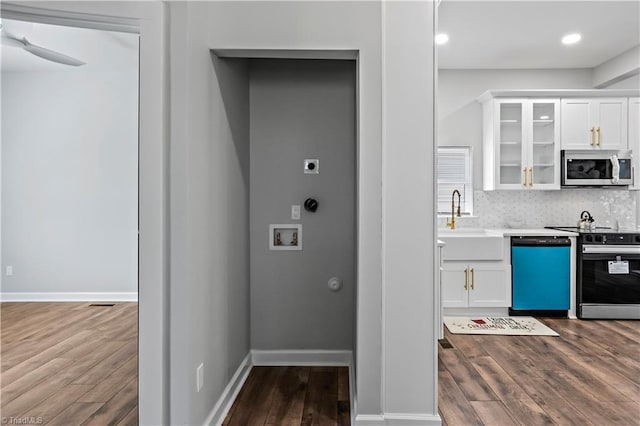 kitchen with dark wood-style flooring, glass insert cabinets, white cabinets, tasteful backsplash, and appliances with stainless steel finishes