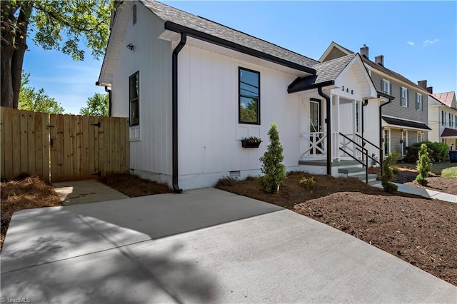 view of front of house with a chimney, fence, and crawl space