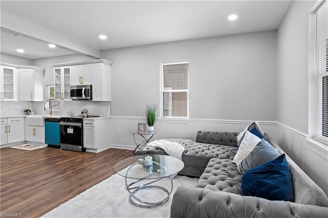 living area with recessed lighting and dark wood-style floors