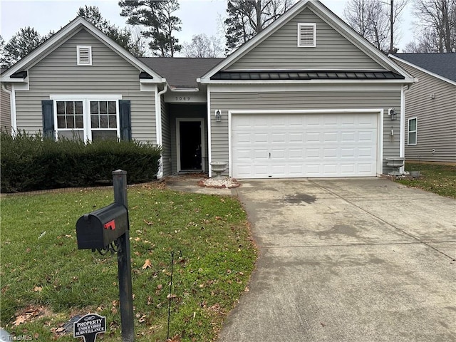 view of front of house with a garage and a front yard