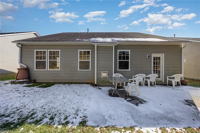 view of snow covered rear of property