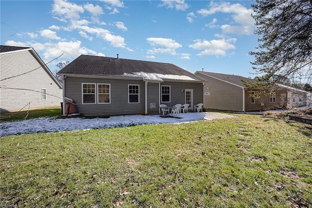 back of property featuring a lawn and a patio