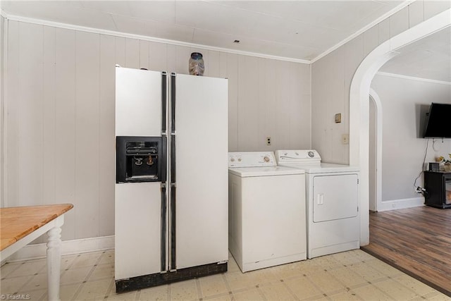 laundry area featuring ornamental molding and washing machine and dryer