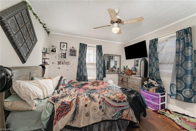 bedroom featuring wood-type flooring, ceiling fan, and crown molding