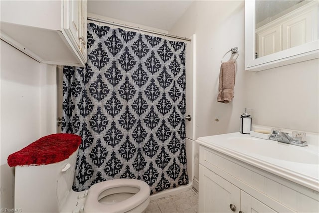 bathroom featuring vanity, tile patterned floors, and toilet