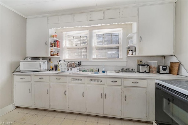 kitchen featuring white cabinets and electric stove