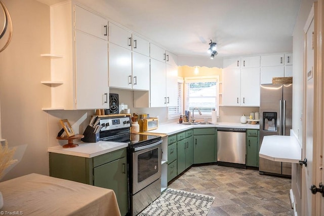 kitchen with sink, white cabinetry, stainless steel appliances, and green cabinetry