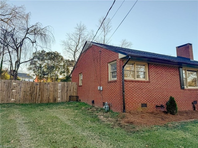 view of home's exterior with a yard