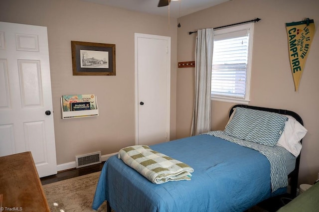 bedroom with ceiling fan and dark wood-type flooring