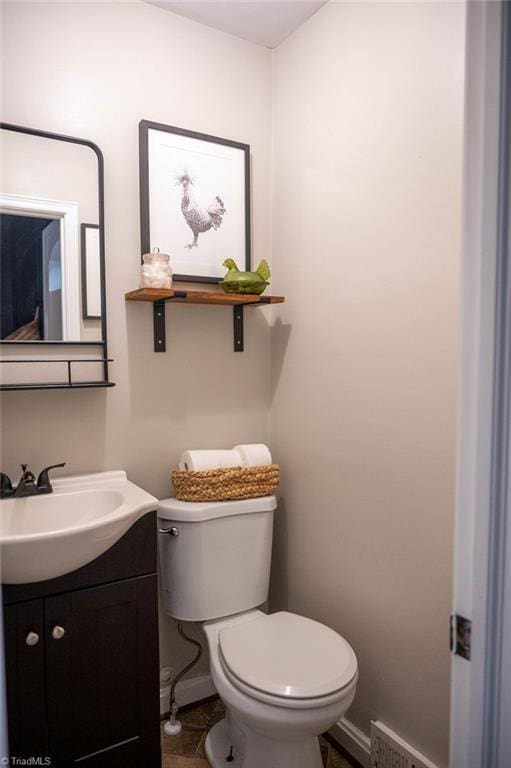 bathroom with tile patterned flooring, vanity, and toilet