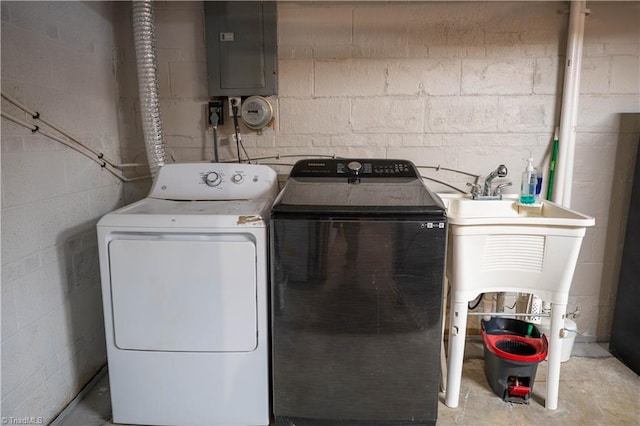 clothes washing area with electric panel and washer and clothes dryer