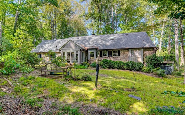 ranch-style house with french doors and a front lawn