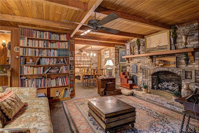 living room featuring ceiling fan with notable chandelier, beam ceiling, wood ceiling, and a fireplace