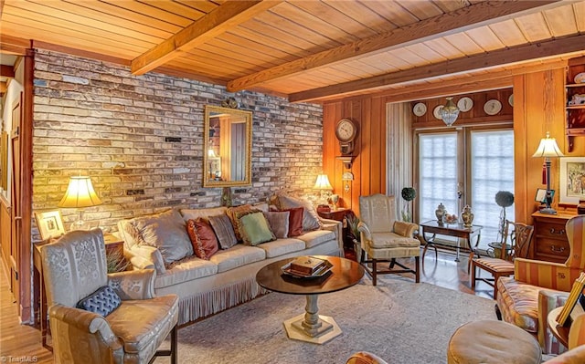 living room with beamed ceiling, wooden ceiling, and brick wall