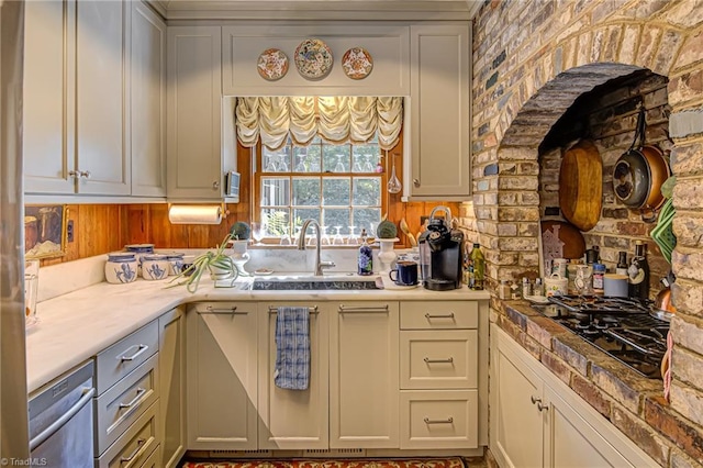 kitchen with stainless steel dishwasher, sink, gray cabinetry, and black gas stovetop