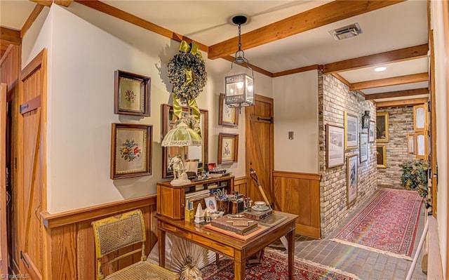 corridor featuring wooden walls and beam ceiling