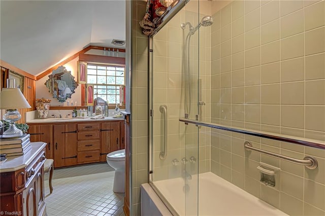 full bathroom with tile patterned floors, toilet, vaulted ceiling, vanity, and shower / bath combination with glass door