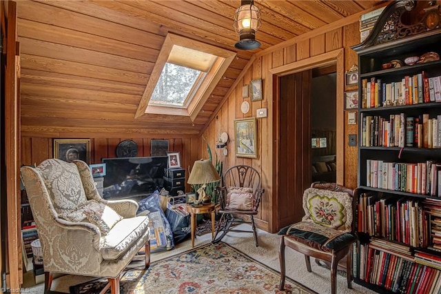 living area featuring wooden ceiling, lofted ceiling with skylight, carpet flooring, and wood walls