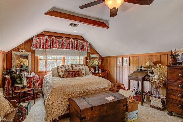 bedroom featuring ceiling fan, lofted ceiling with beams, light carpet, and wooden walls