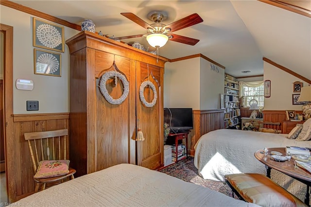 bedroom featuring crown molding, wooden walls, and ceiling fan